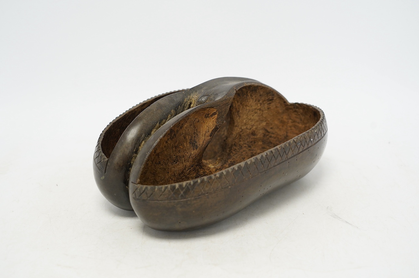 A coco de mer carved dish, 25cm wide, 18cm high. Condition - fair